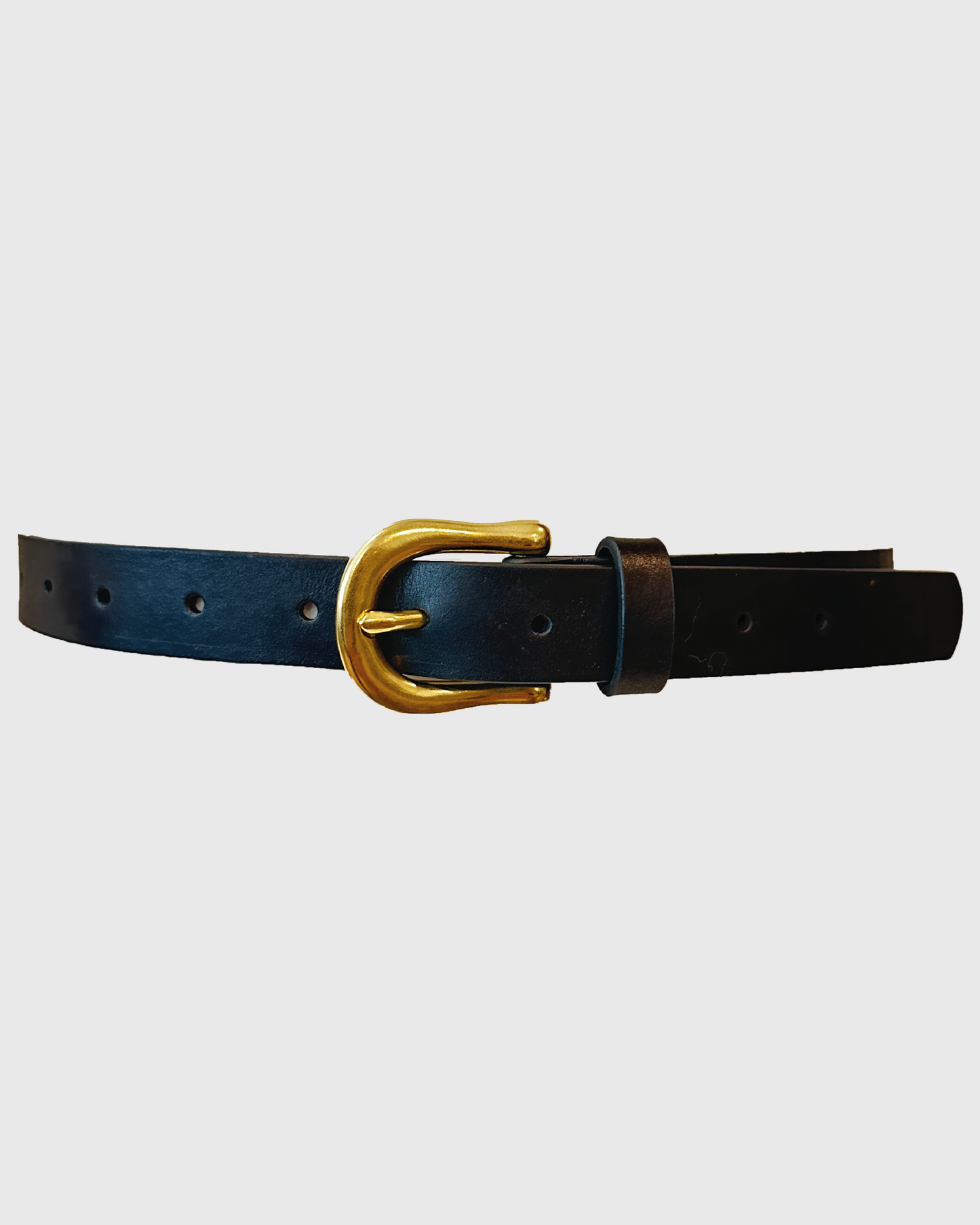Black leather belt with a gold buckle on a light gray background