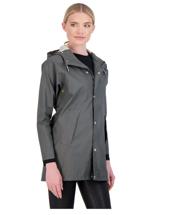 Model wearing Cotes of London The Manchester Raincoat in Gray wearing black pants on a white background