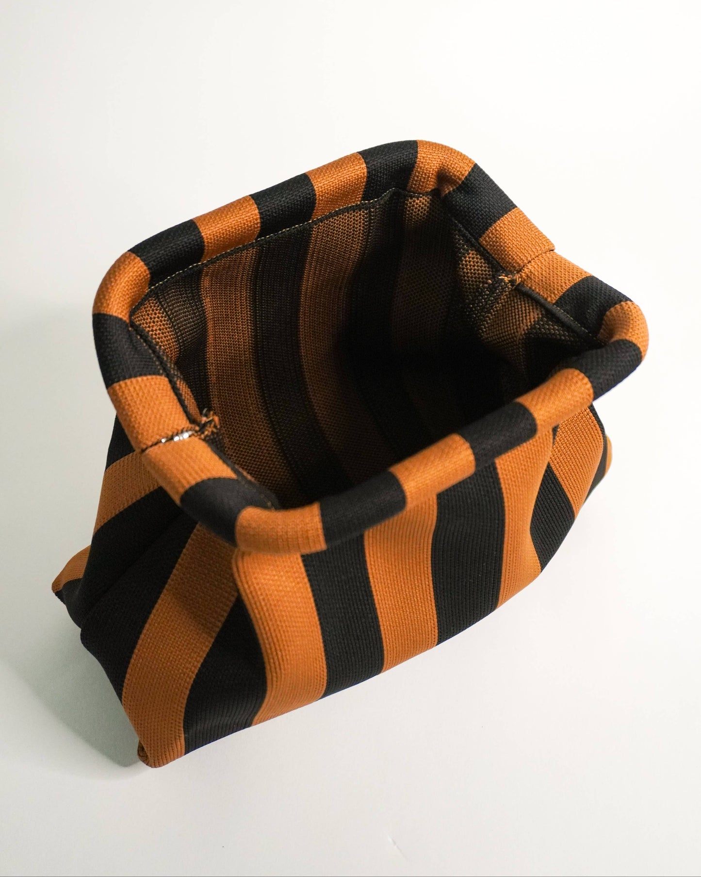 Black and orange striped fabric on a white background