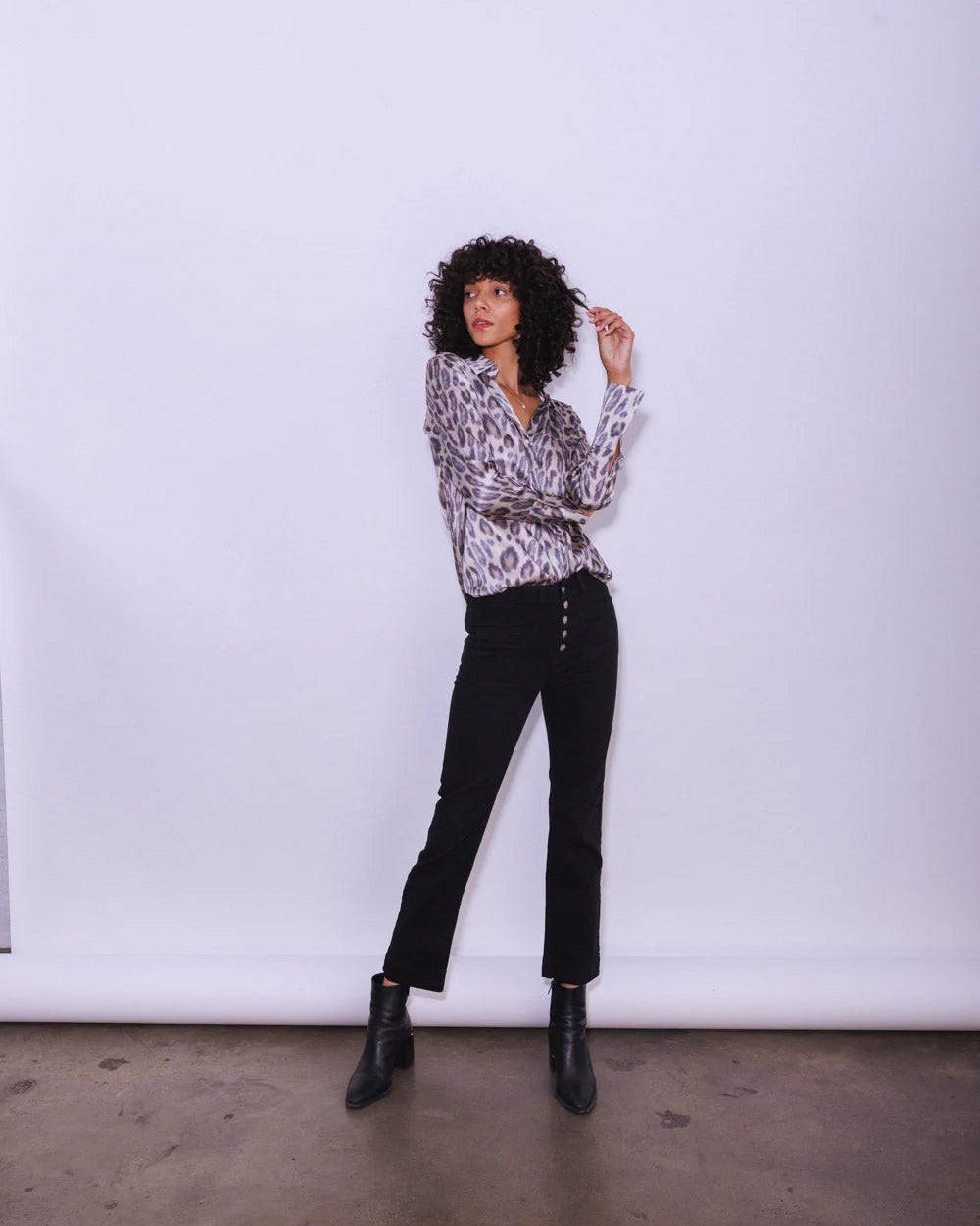 Model wearing the Catherinne Gee Daria blouse in New Leopard standing in front of a white background