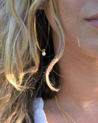 Close up photo of a model wearing the Elli Parr Becca Gold Hoops from the front view