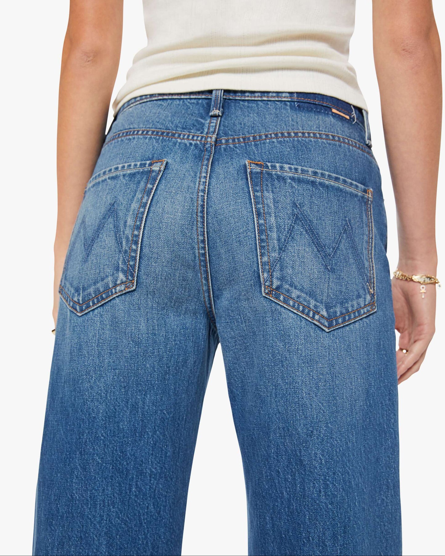 Blue jeans worn by a person on a white background