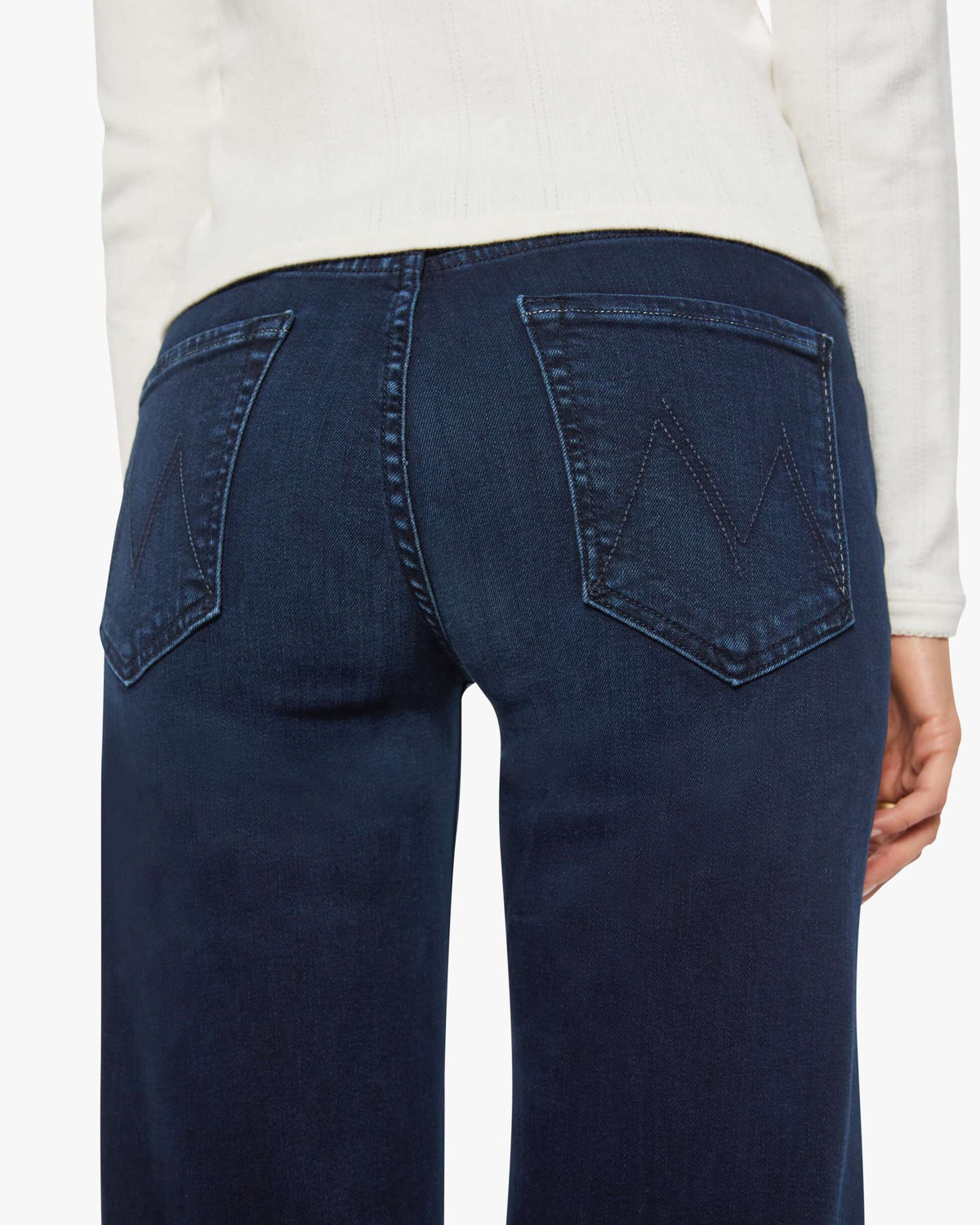 Person wearing blue jeans on a white background
