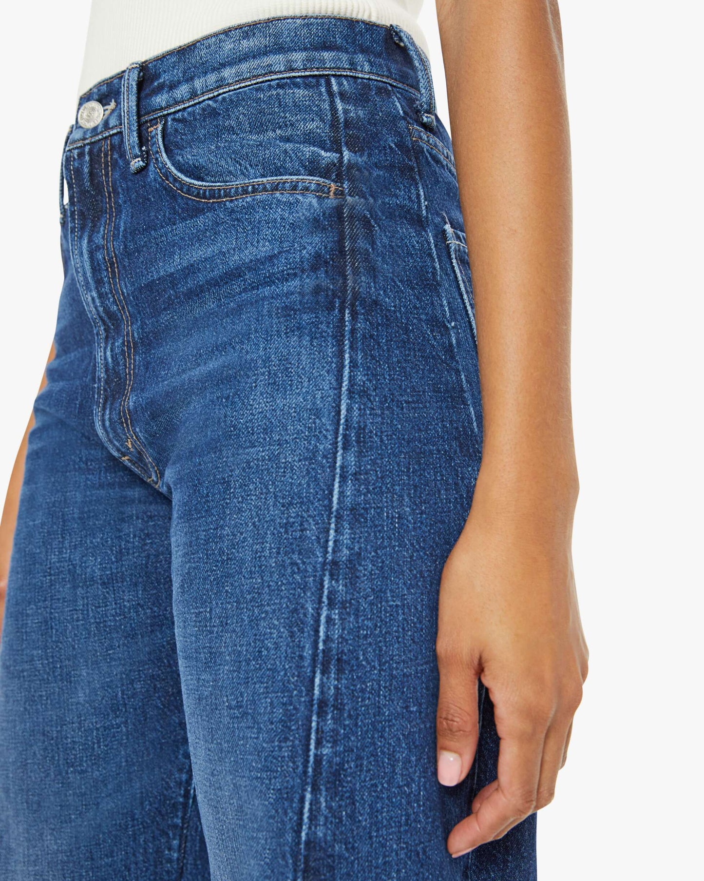 Close-up of blue jeans with a white background