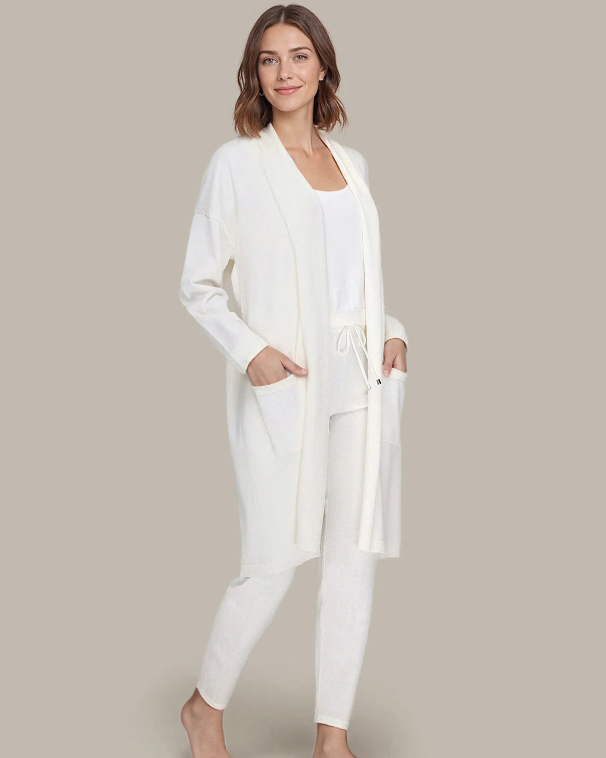 Woman wearing a white loungewear set on a plain background