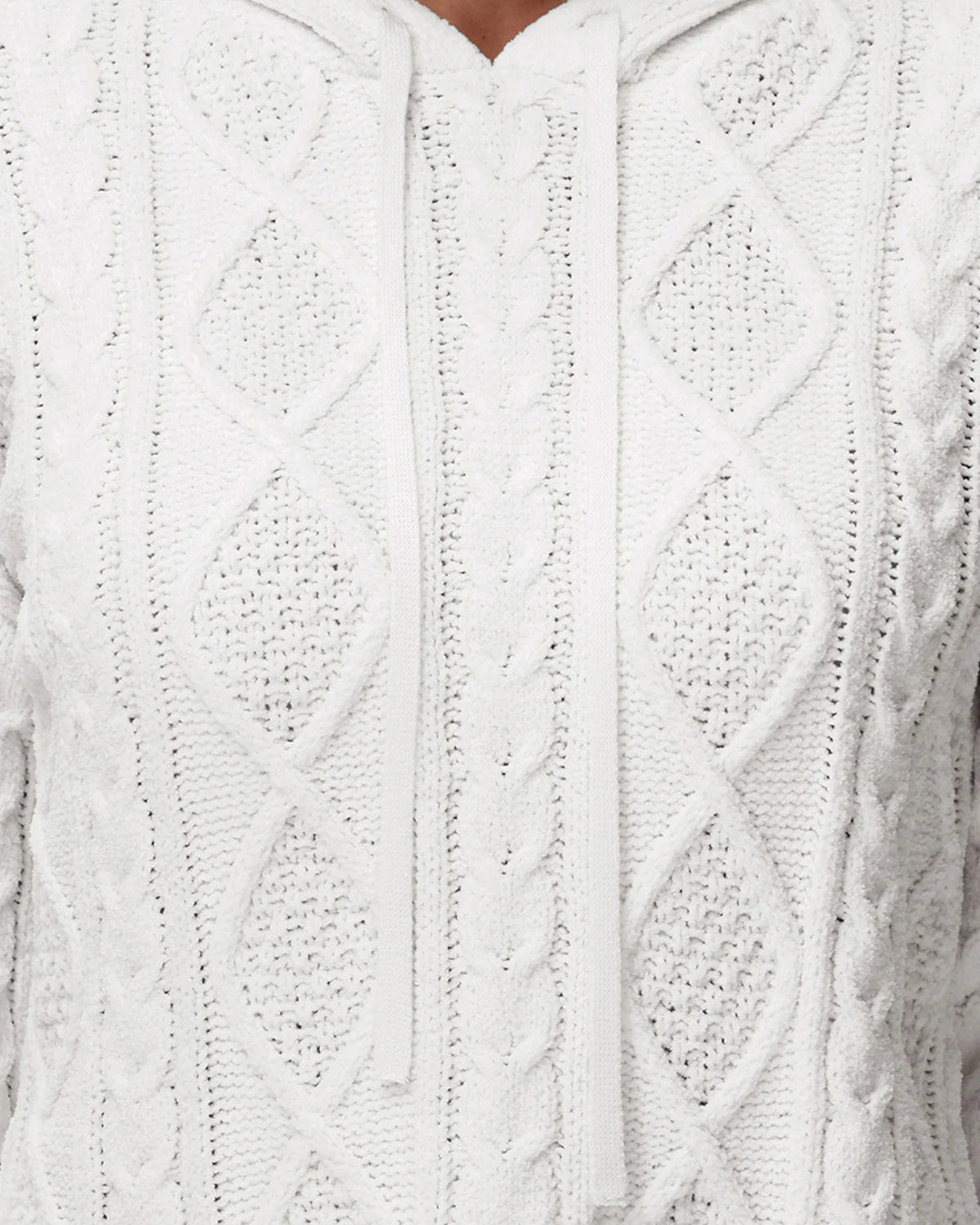 Close-up of a white cable knit sweater