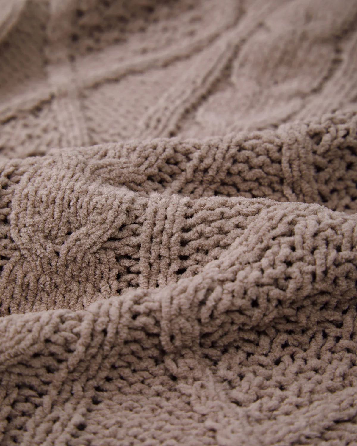 Close-up of a textured brown fabric with intricate patterns