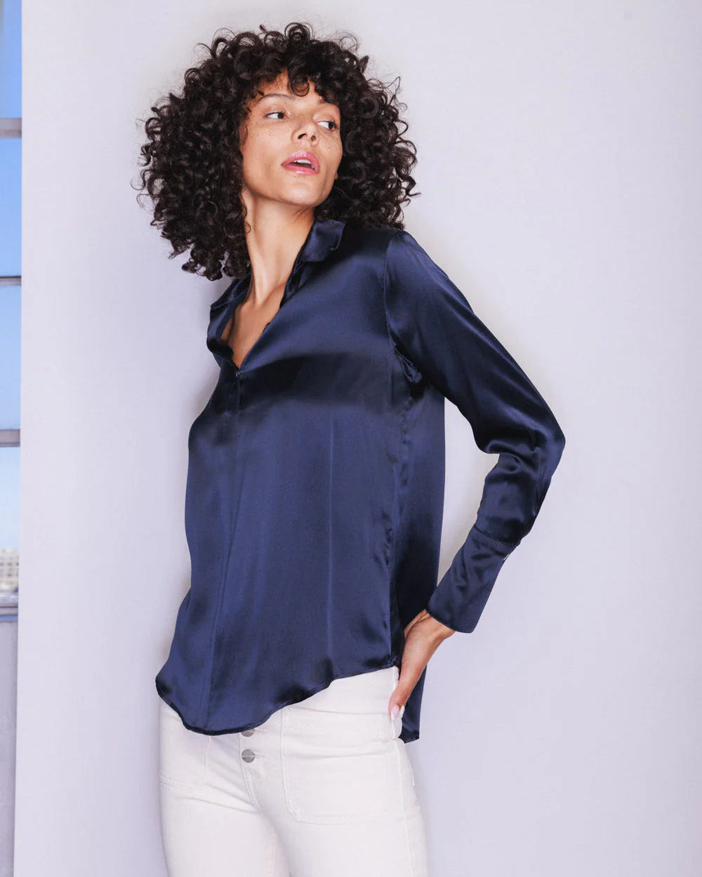 Woman posing wearing the Daria French Cuff blouse in Midnight against a white background.