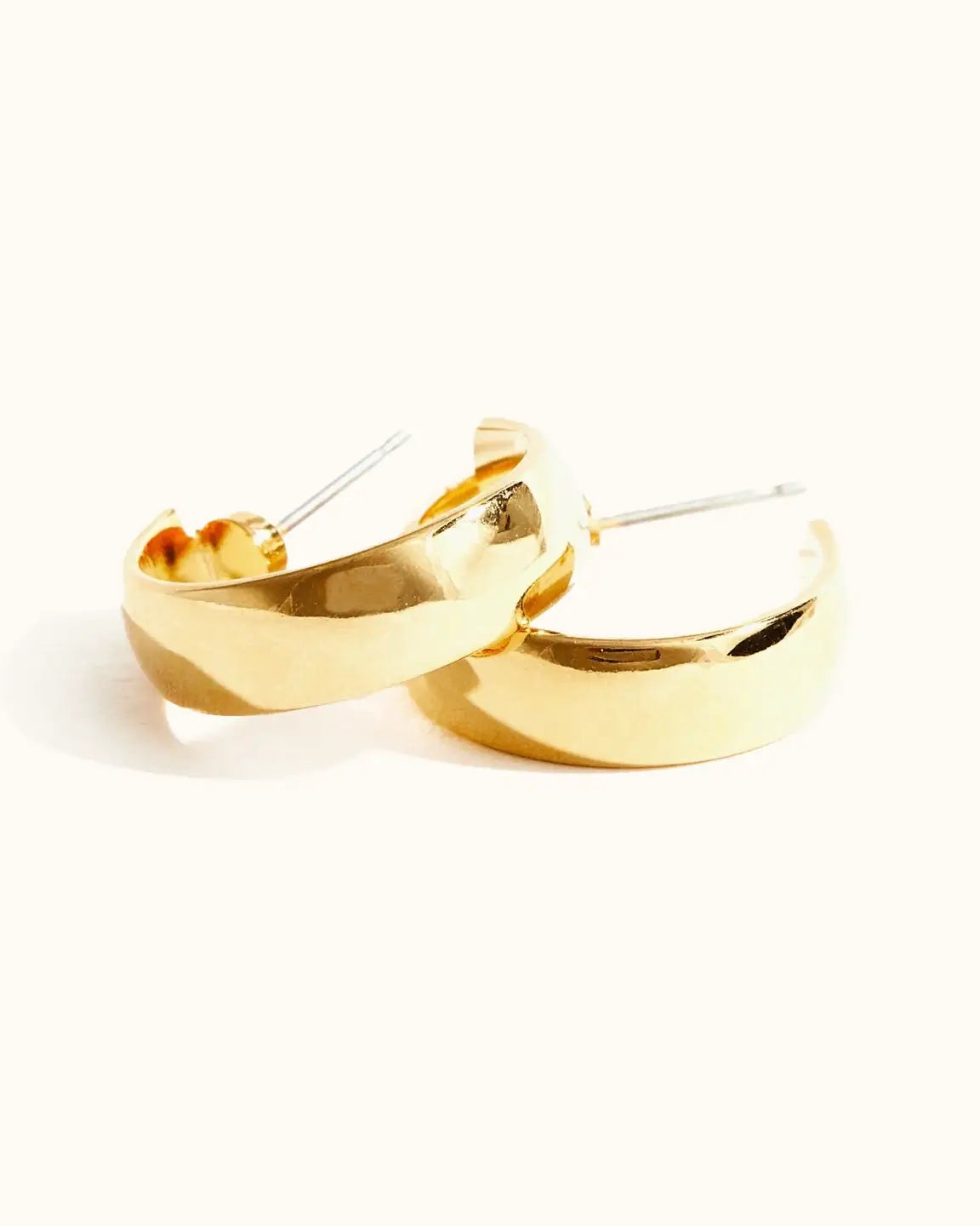 Close up photo of the Able Stride Hoop Earrings in gold against a white background