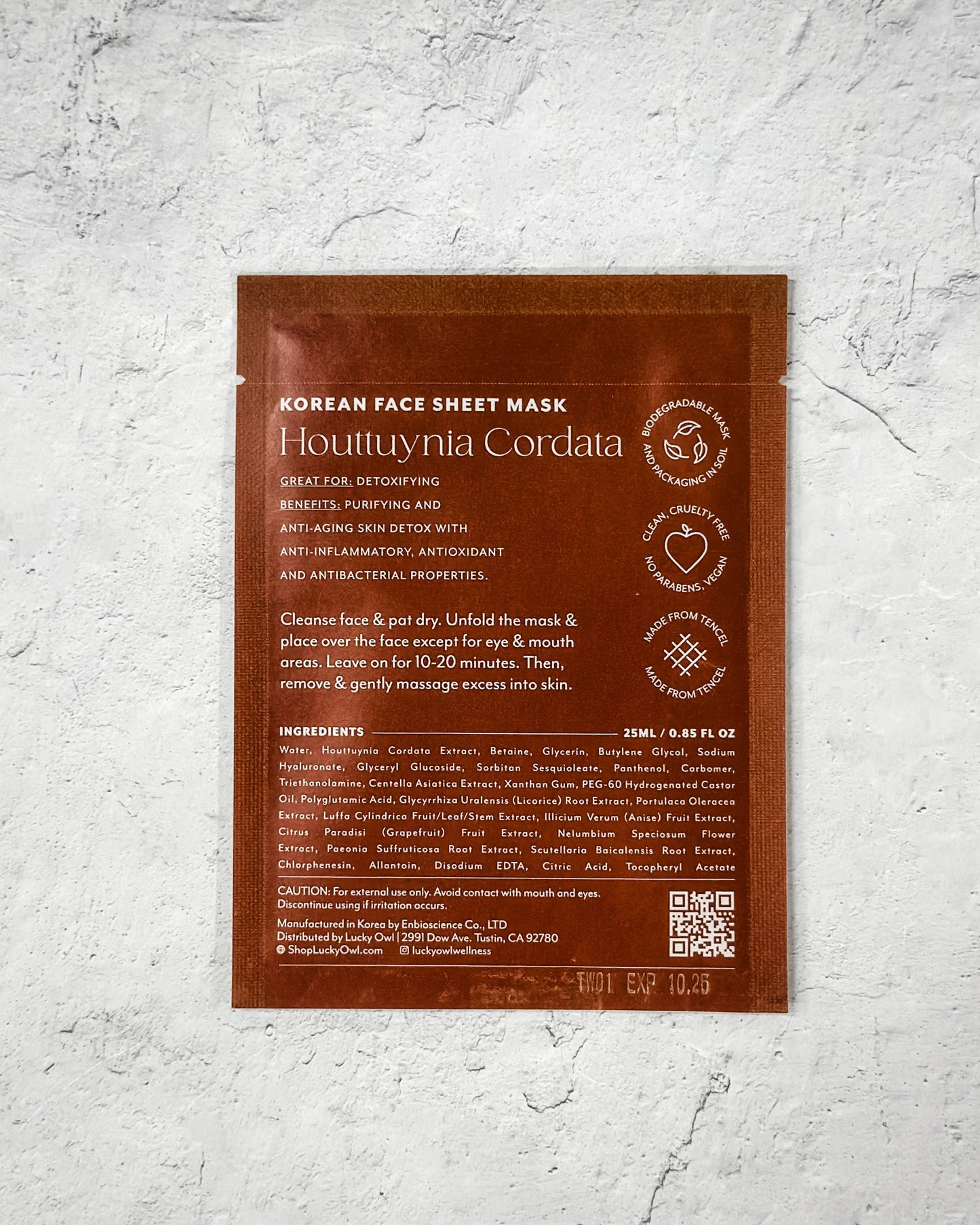 Korean face sheet mask packaging with text on a textured gray background