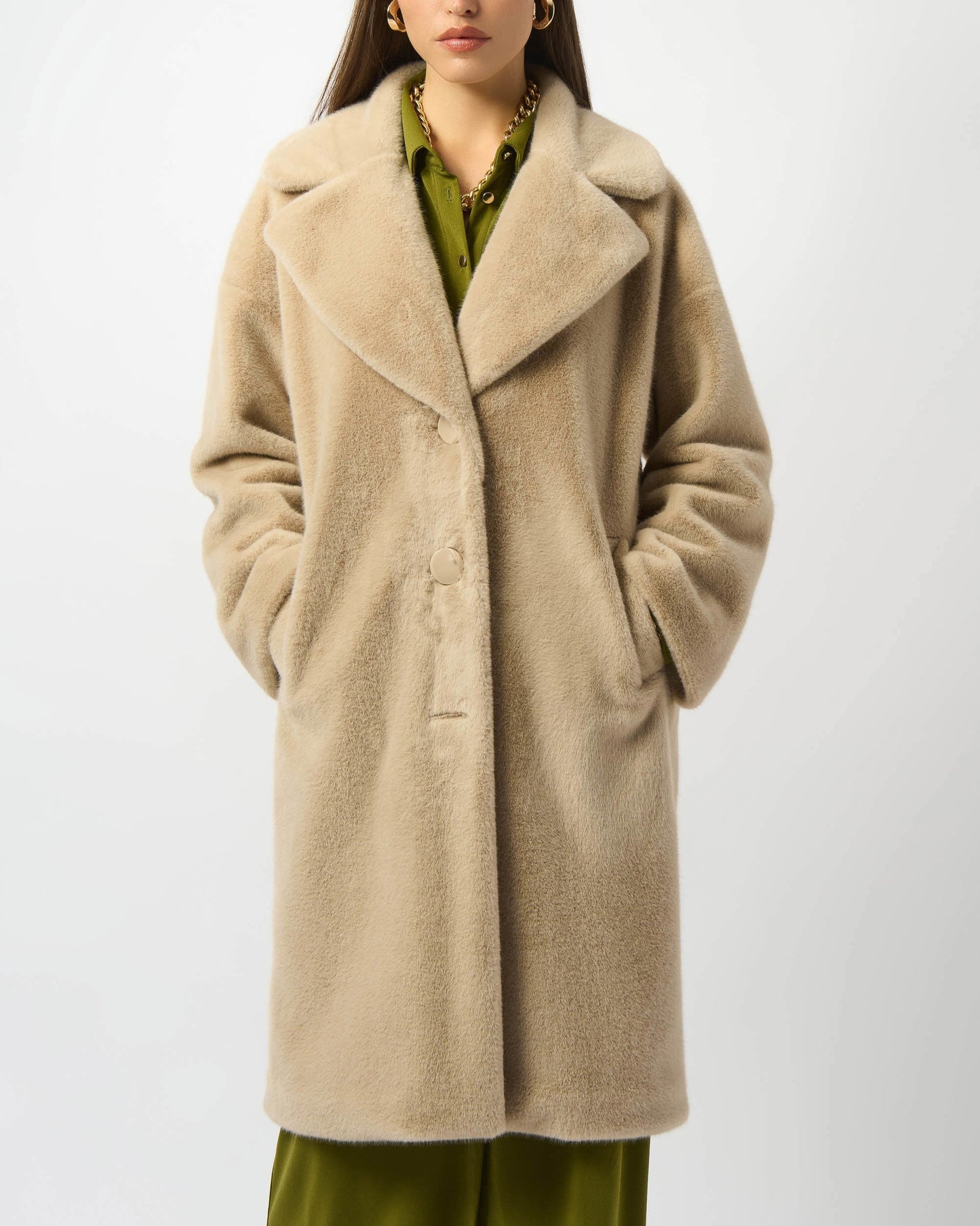 Woman wearing a beige coat on a white background