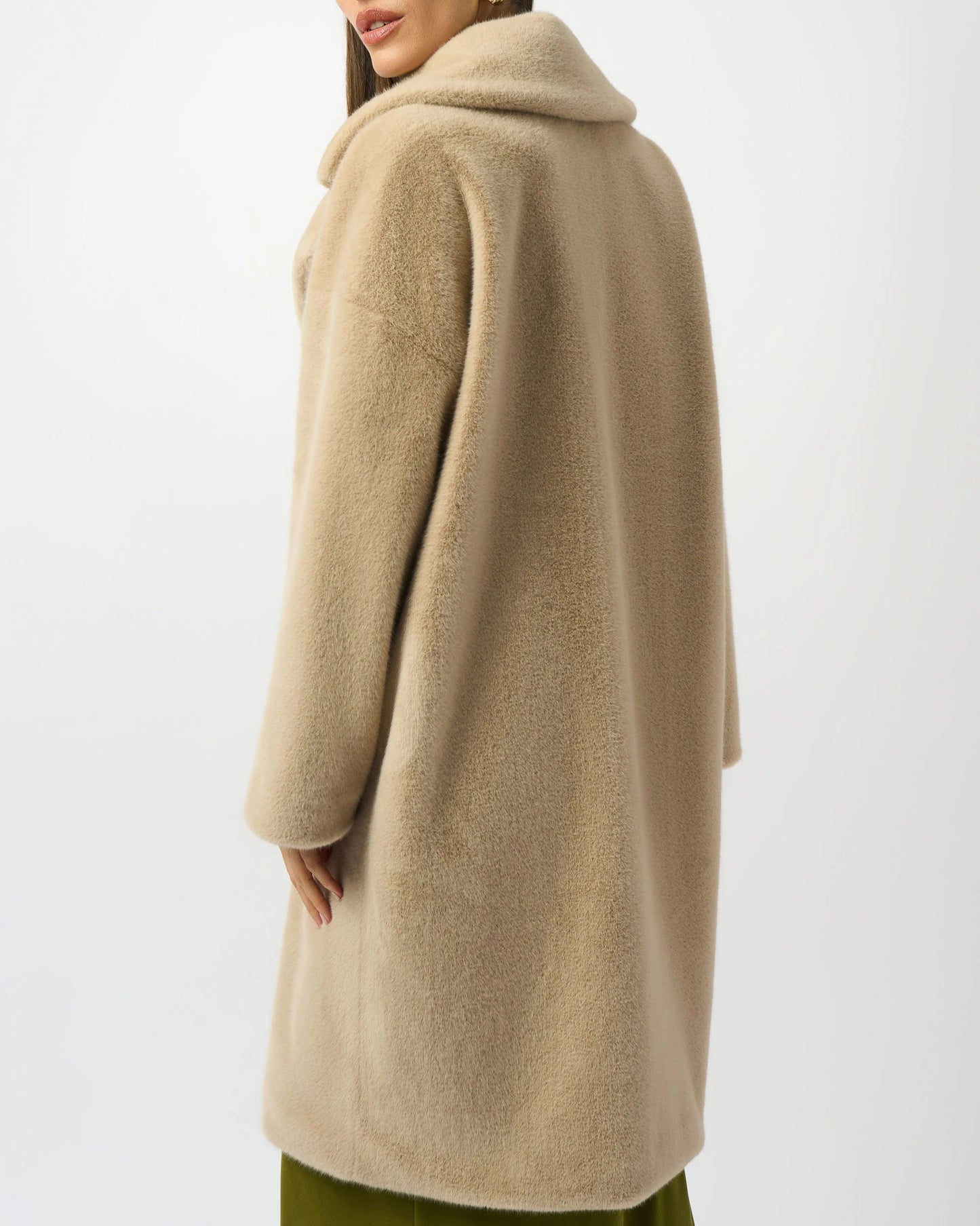 Woman wearing a beige coat on a white background