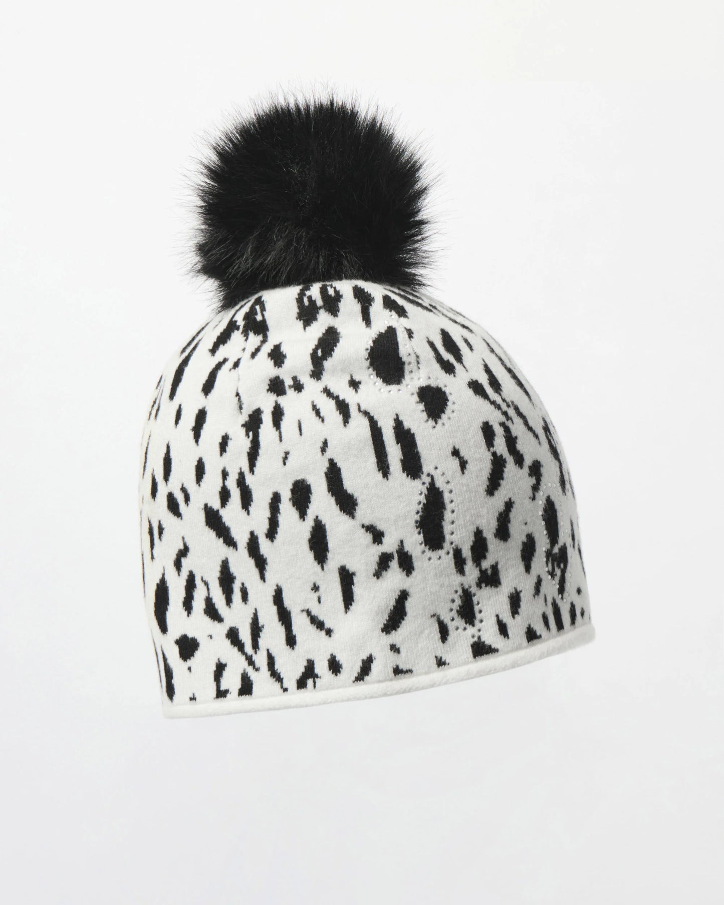 White beanie with black pattern and black pom-pom on a white background