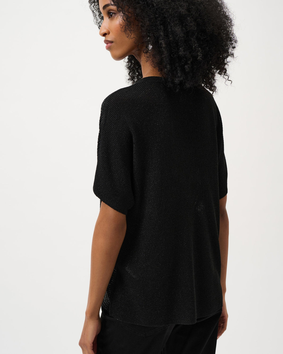 Person wearing a black t-shirt and pants on a white background