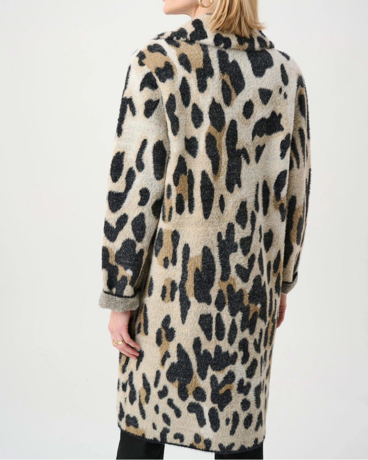 Woman wearing a leopard print coat on a white background