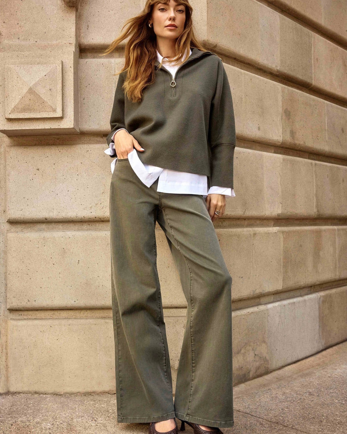 Model is wearing Joseph Ribkoff GOLDIE Classic Wide Leg Jeans in Avocado on a beige background.