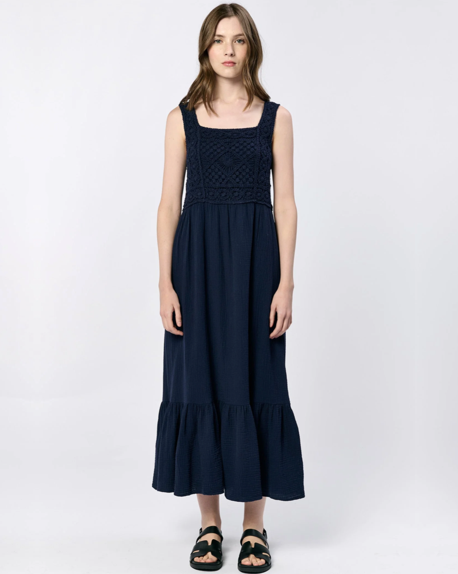 Front view of the Dear John Chasity dress in navy on a model wearing black sandals standing in front of a white background
