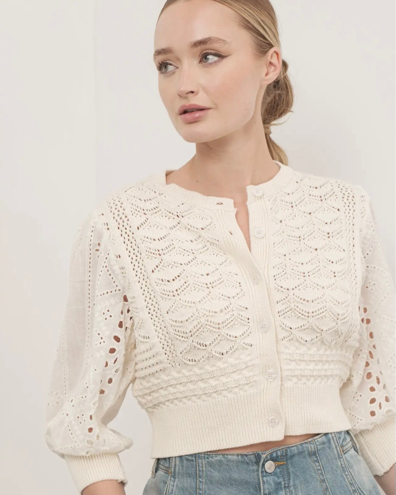 Model wearing the Hendry 3/4 sleeve sweater in cream in front of a white background.