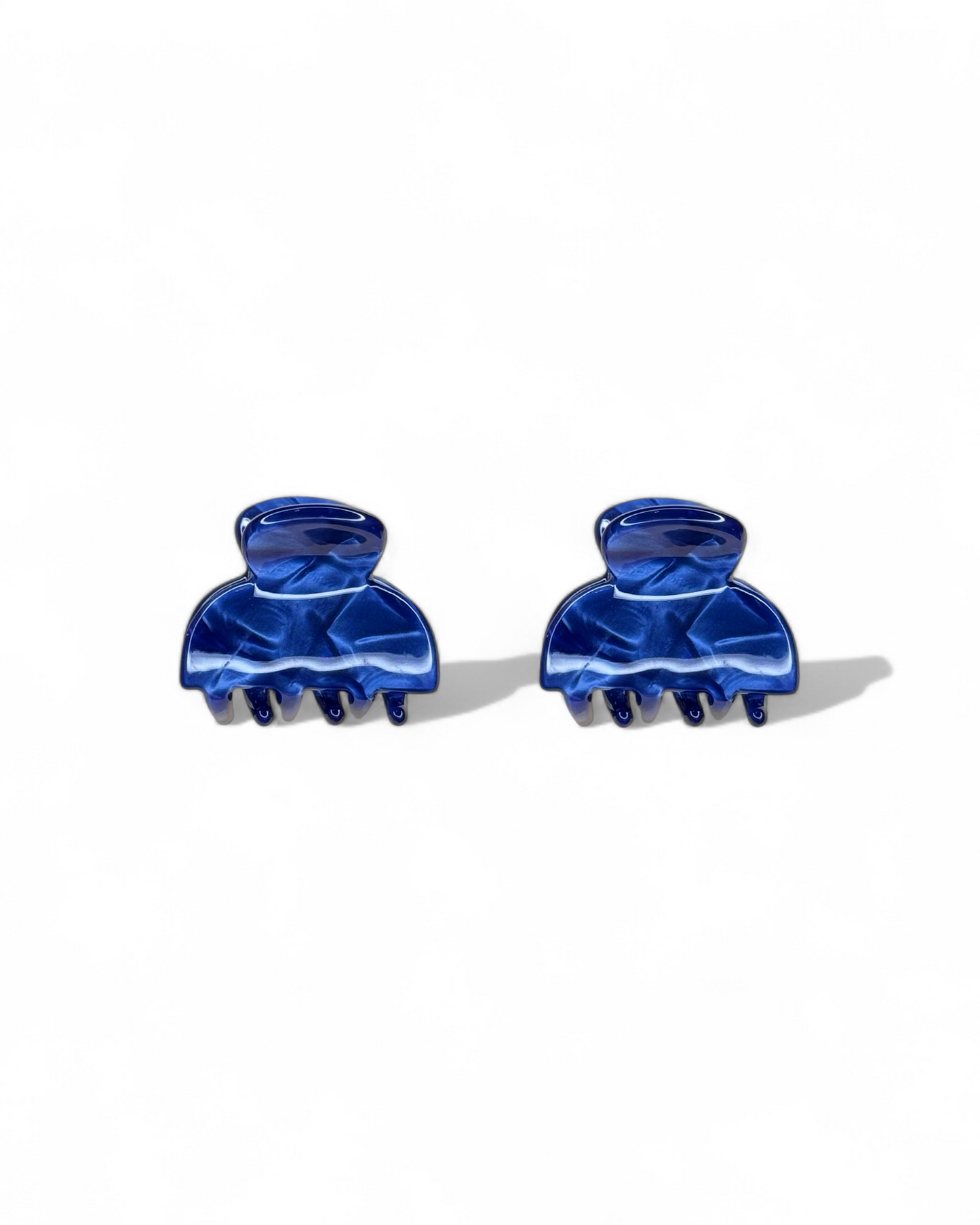 Two blue hair clips on a white background