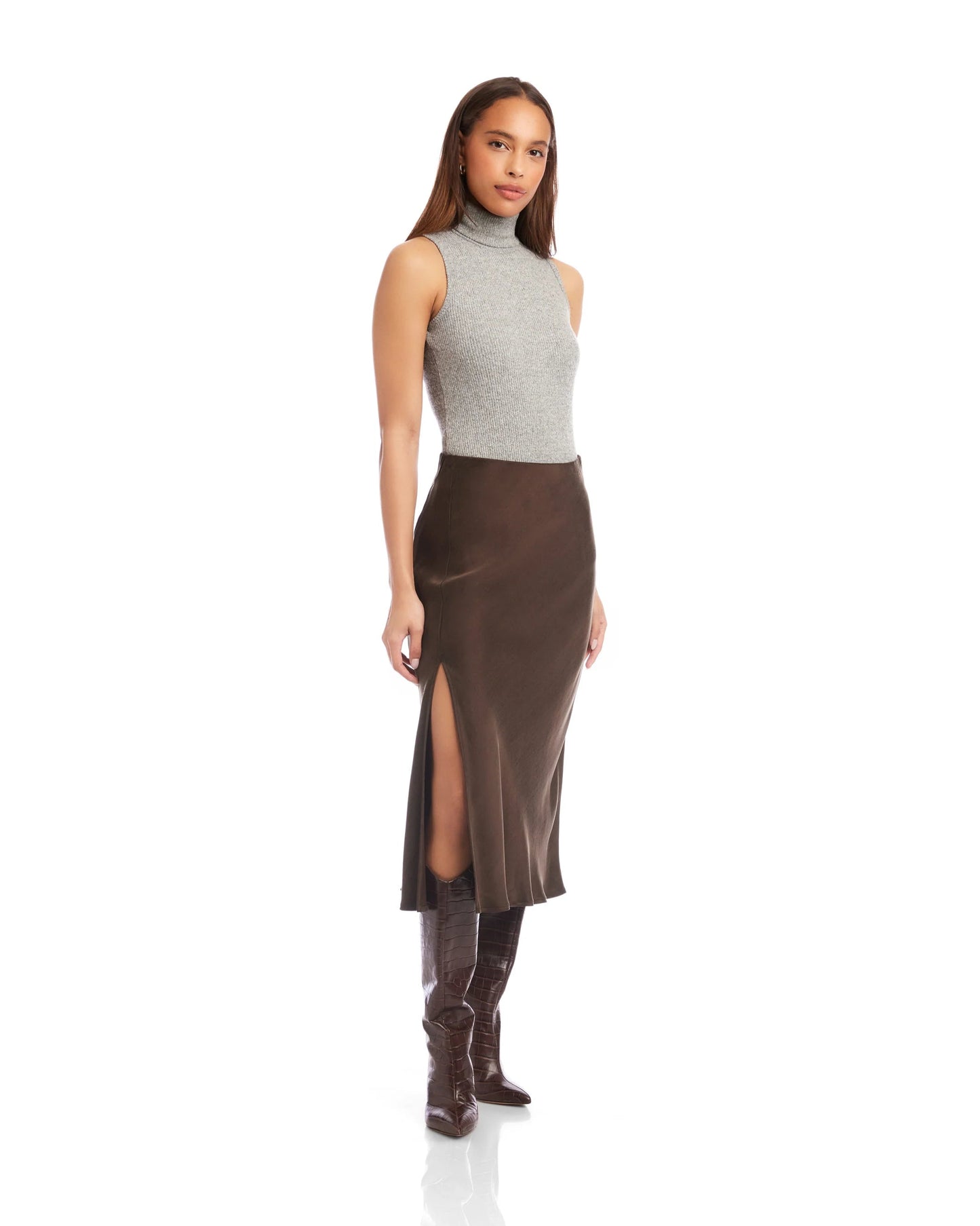 Model is wearing Fifteen Twenty Brielle Midi Skirt in color Brown on a white background.