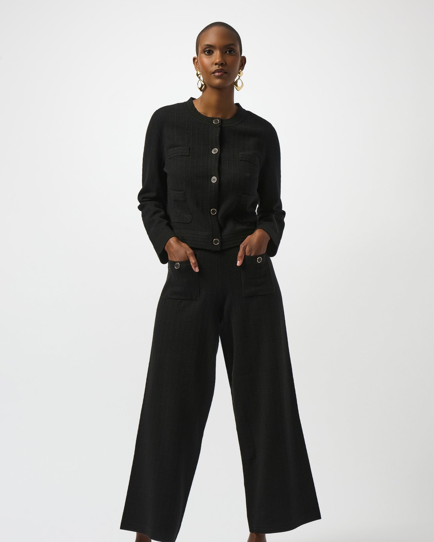 Model is wearing Joseph Ribkoff Sweater Knit Button Front Jacket in black with black knit pants on a white background