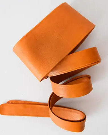 Orange leather wrap belt on a white background
