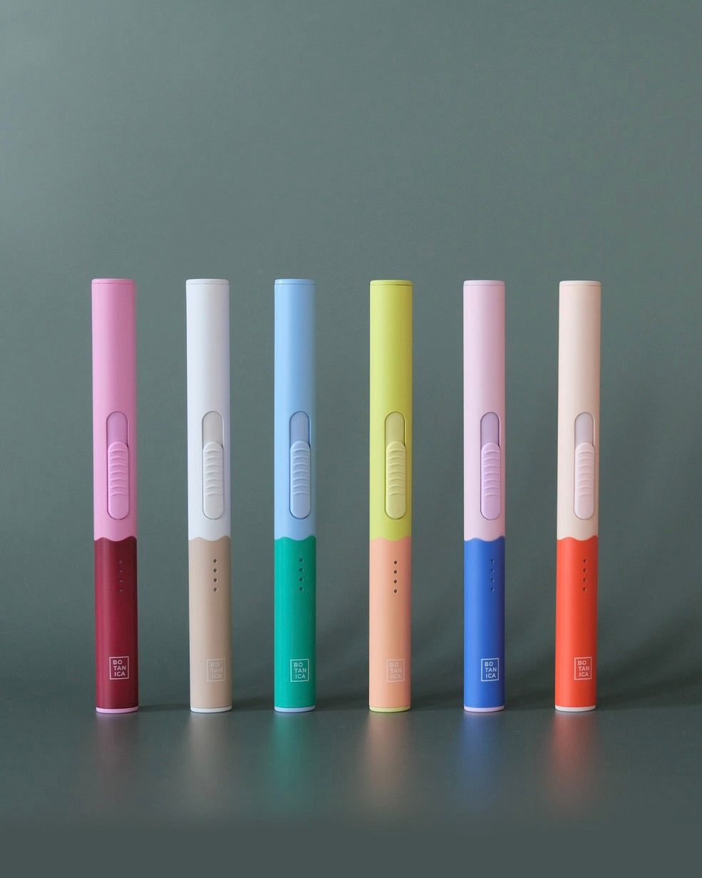 Photo of the Botanica flameless lighter in vaious colors lined up in front of a grey background