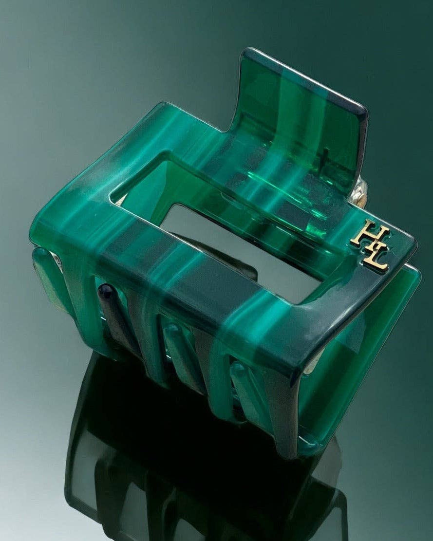 The HoneyLux Ecofriendly Acetate Midi Clip in Emerald on a reflective background