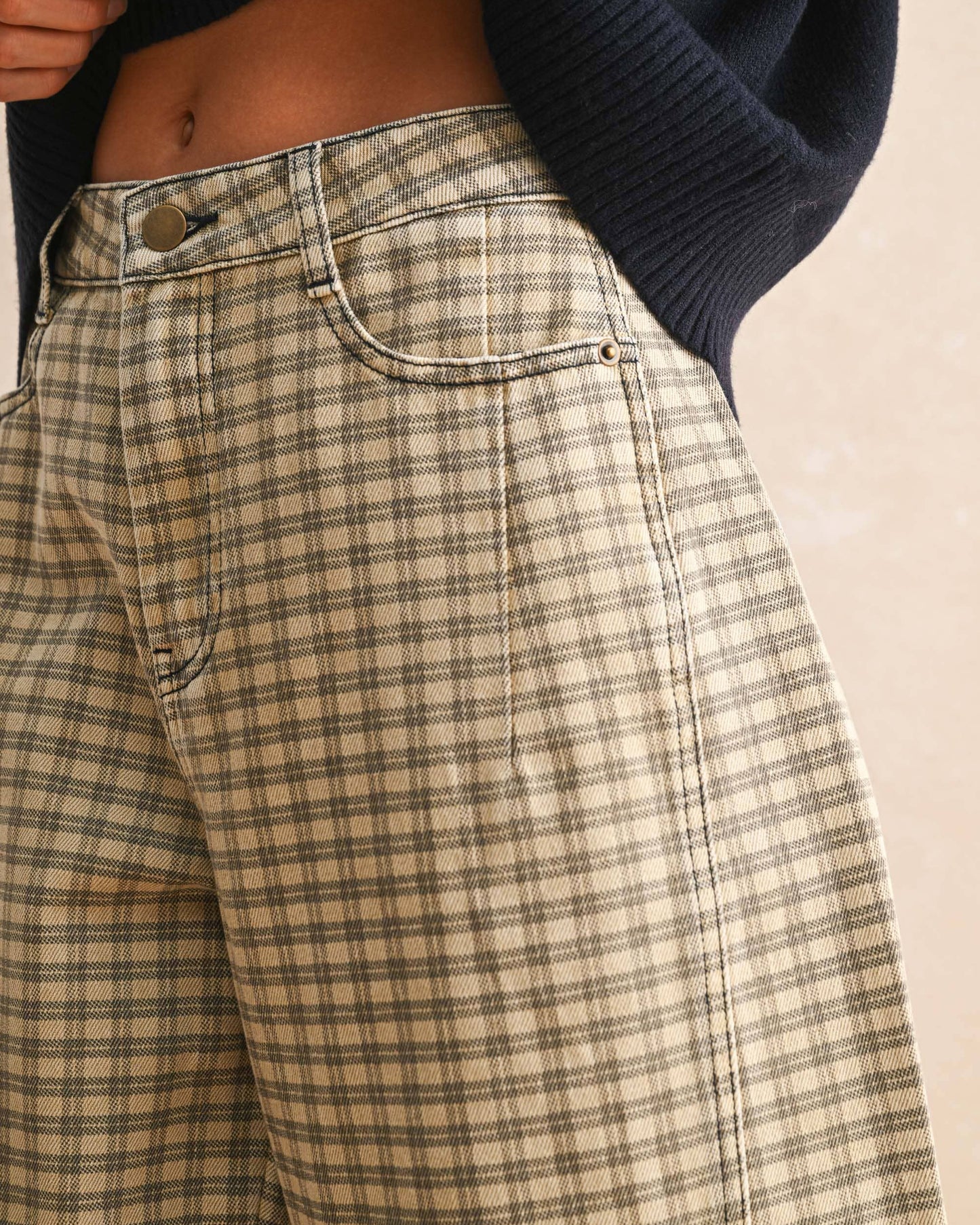 Plaid pants worn by a person with a neutral background