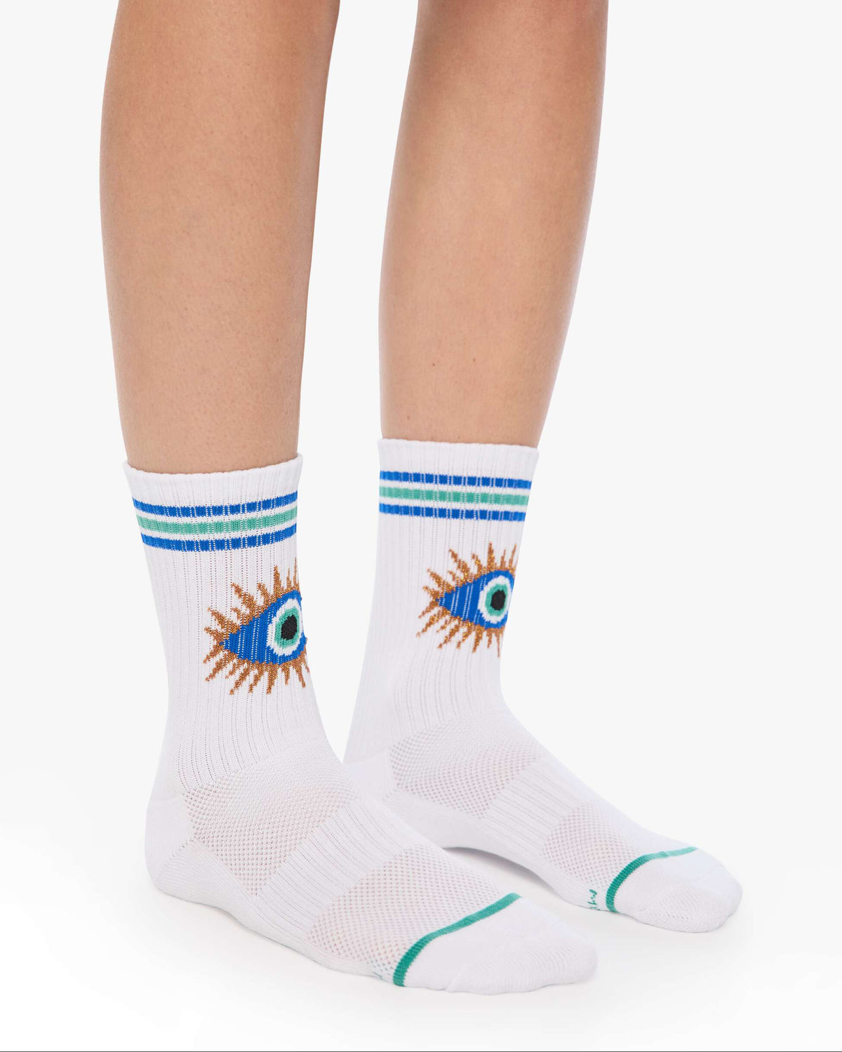 White socks with eye design and blue stripes worn by a person on a white background