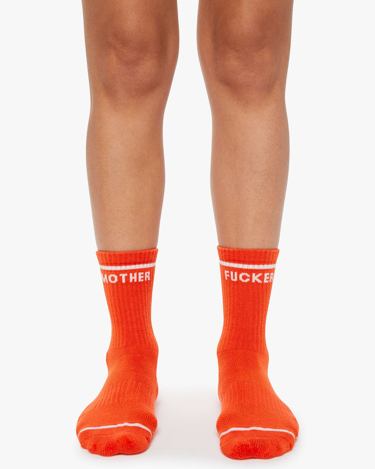 Orange socks with text worn by a person on a white background