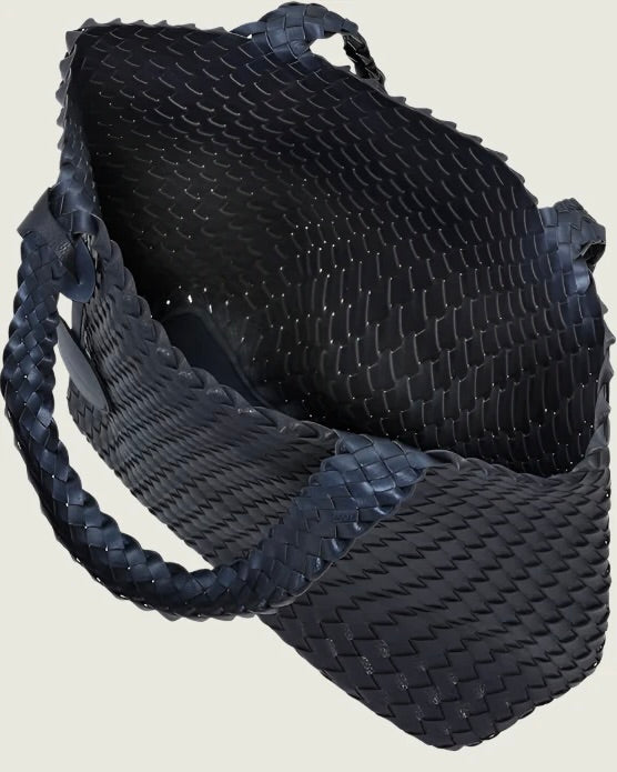 Black woven handbag on a light beige background