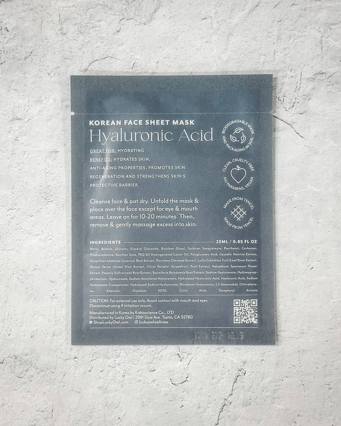 Korean face sheet mask packaging with text on a gray textured background