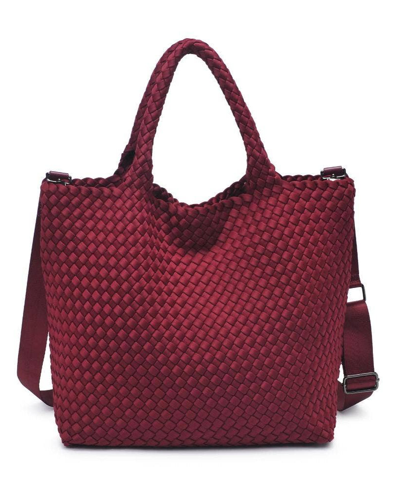 Red woven handbag with a shoulder strap on a white background