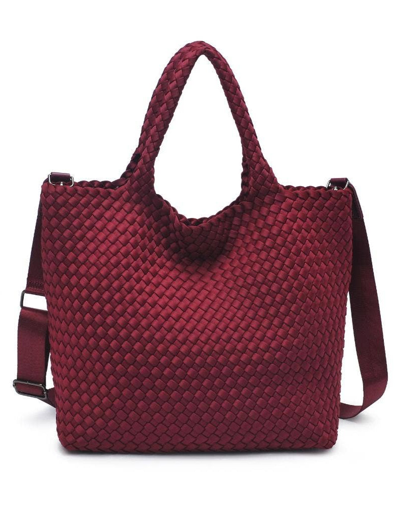 Red woven handbag with a shoulder strap on a white background