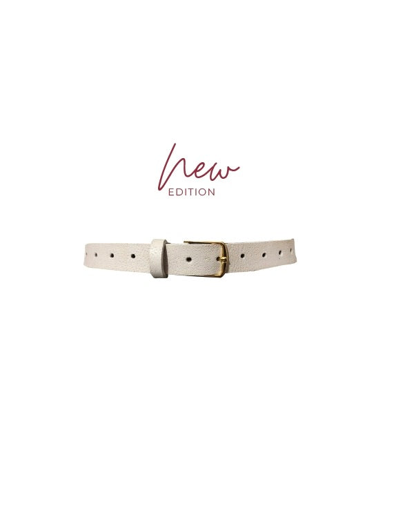 Close up view of the Ada leather detail jean belt in bone in front of a white background with the words new editions written across the top