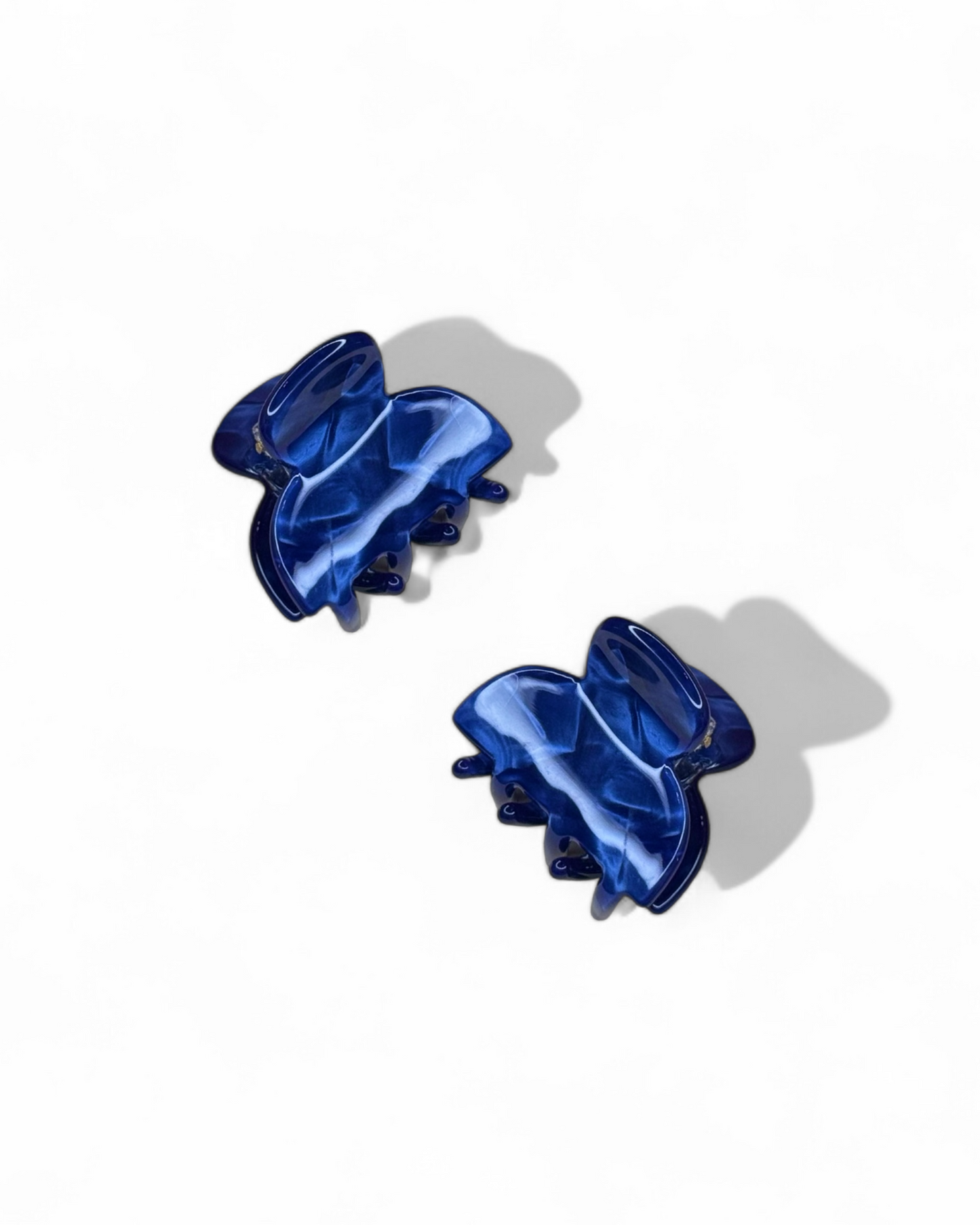 Two blue hair clips on a white background