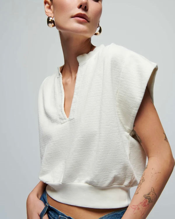 Close up of a model wearing the Nation Lenon crewneck sweatershirt in white in posing in front of a white background.