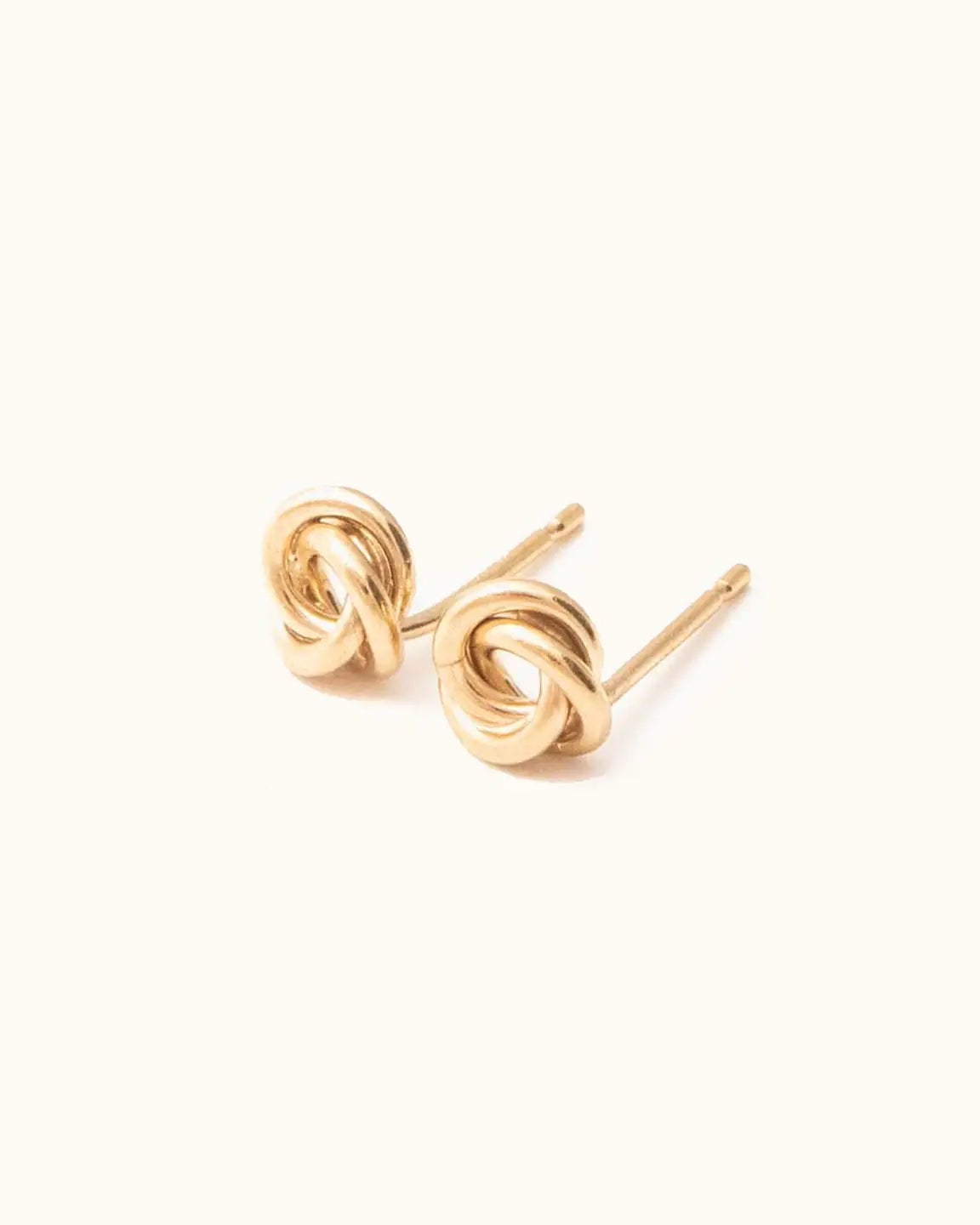 Close up photo of the Able Evermore Stud Earrings in gold against a white background