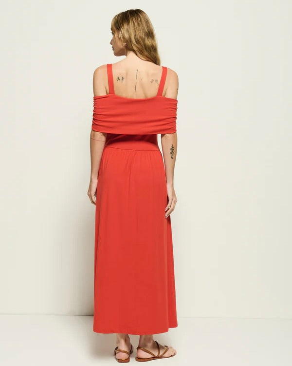 Back view of the Nation Tamaira Dress on a model looking over her shoulder standing in front of a white wall.