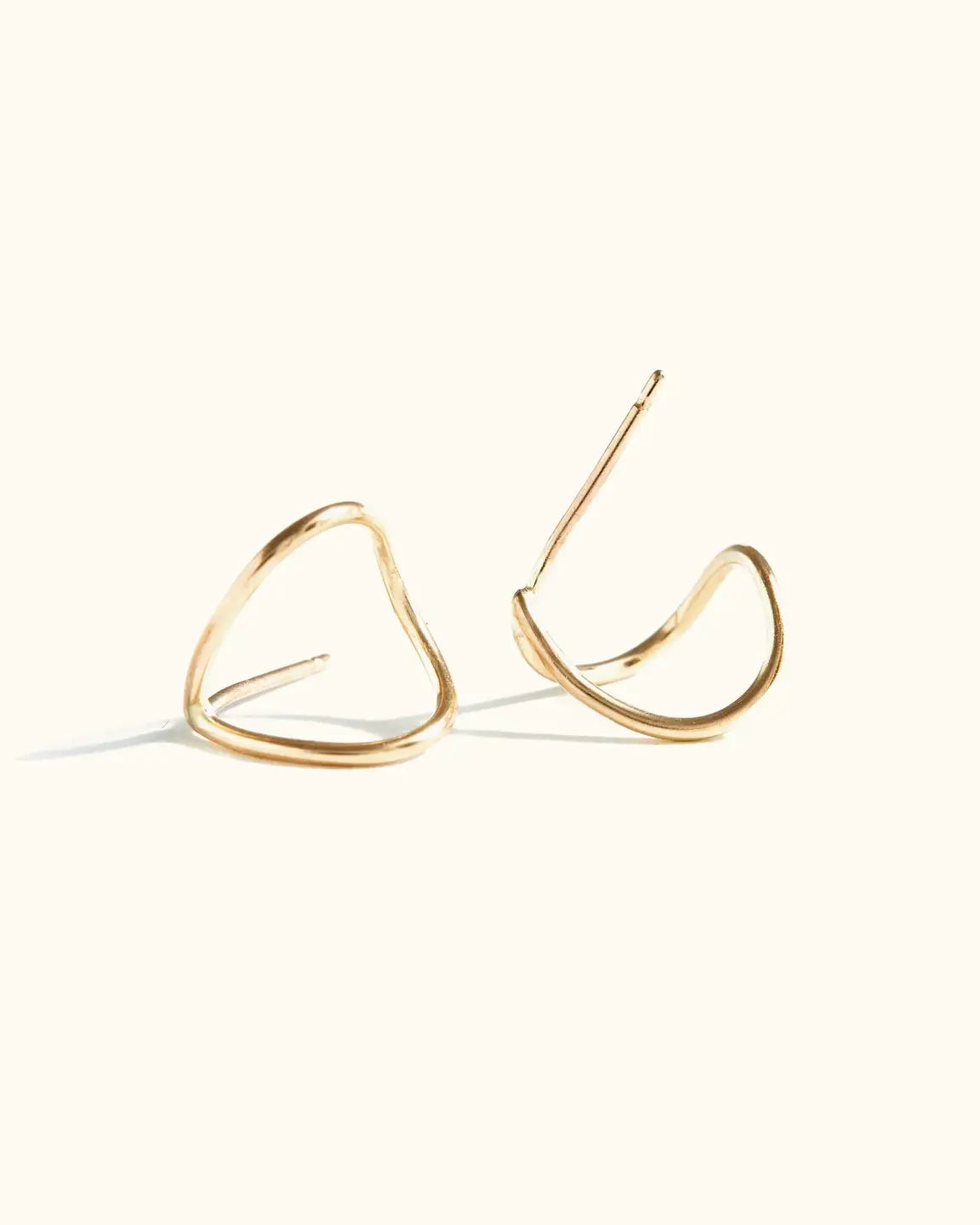 Close up photo of the Able Ear Hugs in gold laying against a white background