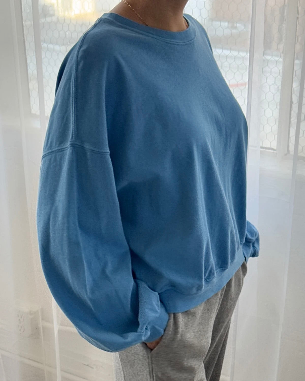 Woman wearing Le Bon Shoppe cali jersey in yacht blue in front of white curtain