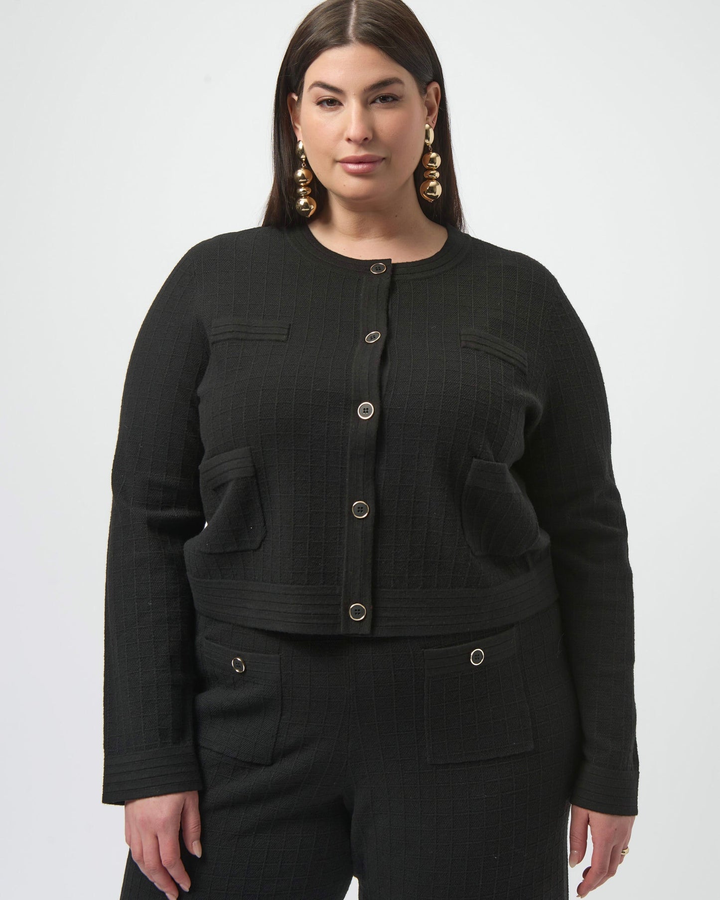 Model is wearing Joseph Ribkoff Sweater Knit Button Front Jacket in black with black knit pants on a white background