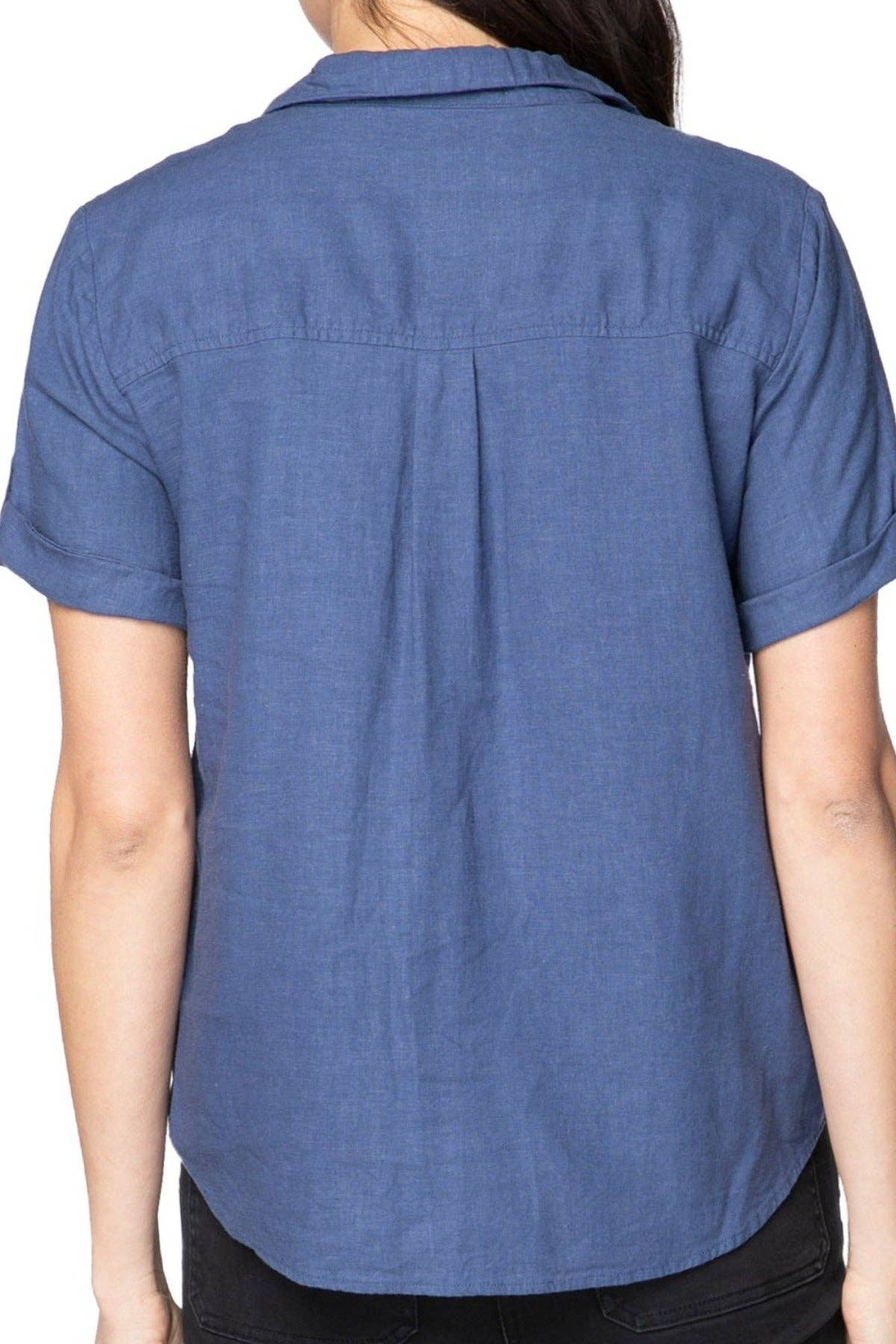 Blue short-sleeve shirt worn by a person on a white background