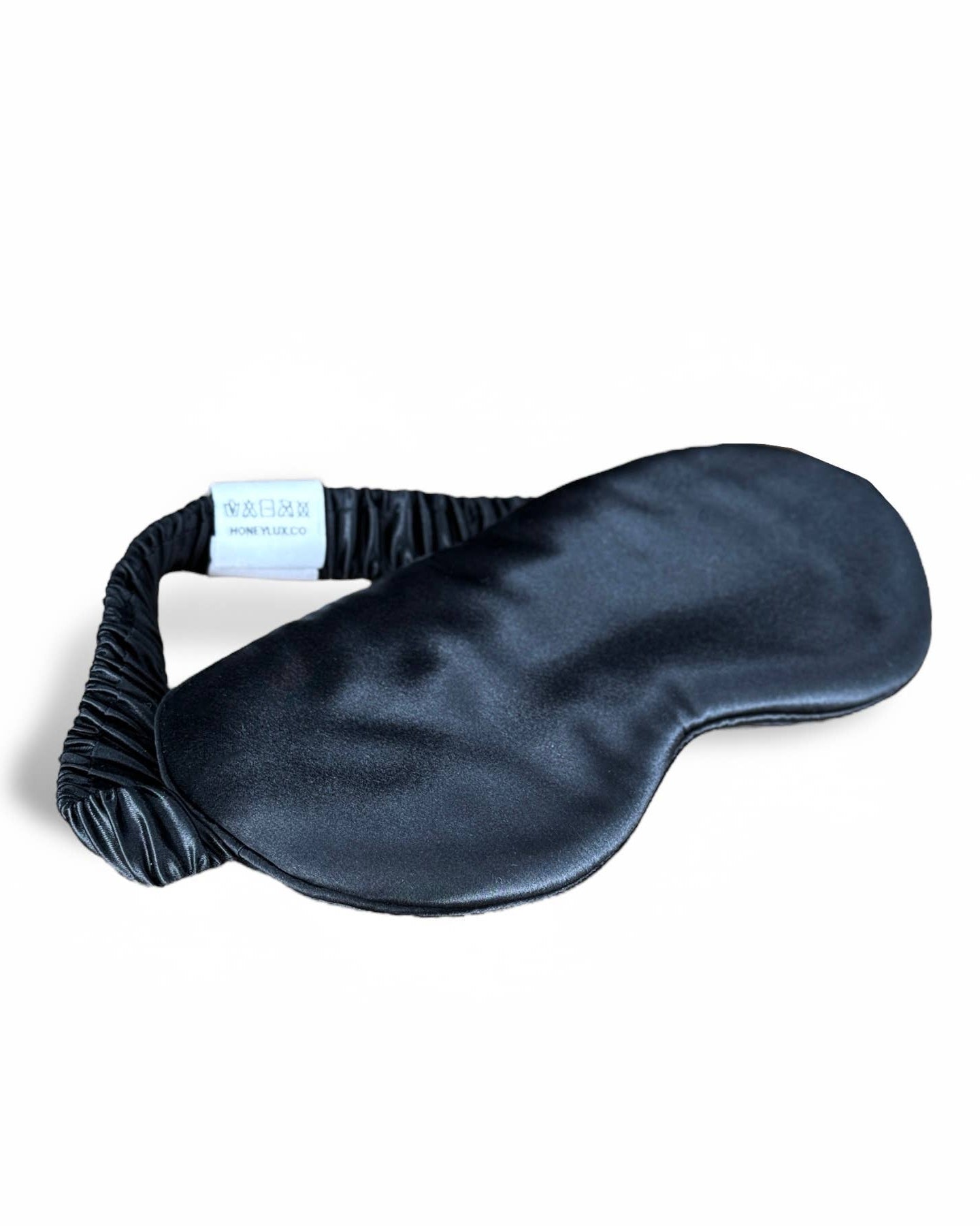 Black HoneyLux silk eye mask on a white background