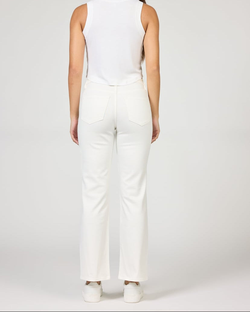 Person wearing a white sleeveless top and pants on a plain background