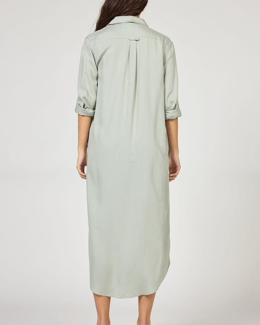 Woman wearing a light green dress on a white background