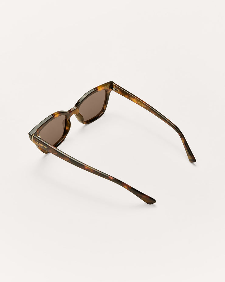 Sunglasses with tortoiseshell frame and brown lenses on a white background