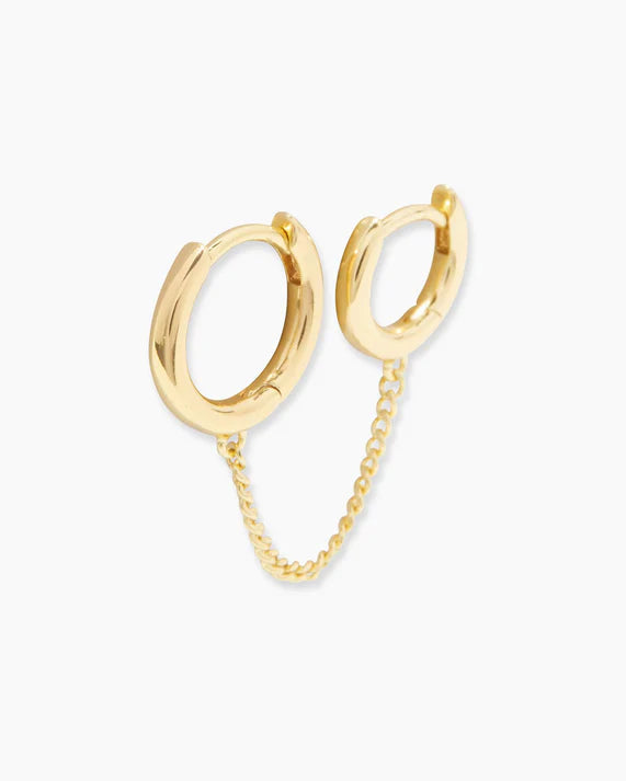 Gold hoop earrings with a chain on a white background