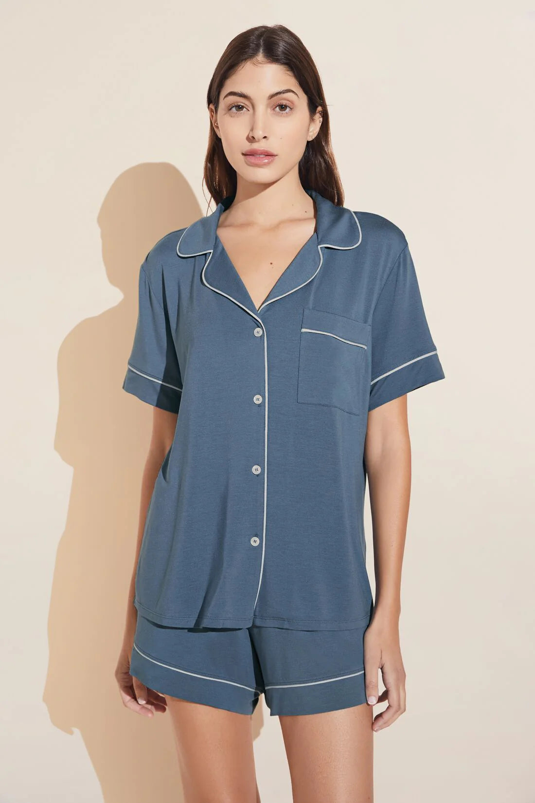 Model wearing Eberjey Gisele relaxed short pj set in coastal blue/white on a yellow background